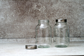 Obraz na płótnie Canvas Two empty glass jars with lids for fermentation