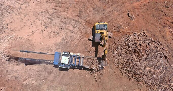 Aerial view on wood chipping machine the chipper process in construction site