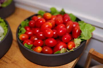 Closeup Cherry Tomatoes with salad on black bowl