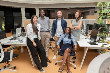 Portrait of a successful creative multi-ethnic business team looking at the camera and smiling, in a coworking space