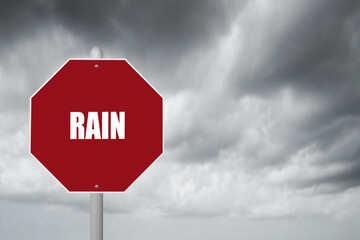 Red stop sign with stormy background and Rain text.
