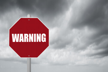 Red stop sign with stormy background and Warning message.