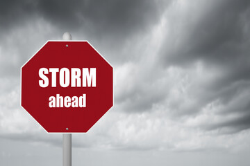 Red stop sign with stormy background and Storm ahead warning.