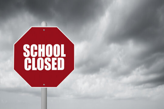 Red stop sign with stormy background and School Closed announcement.