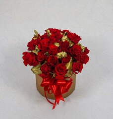 25 red roses in a round box.