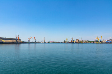 Fototapeta premium Photo of the pier and port cranes on a summer day