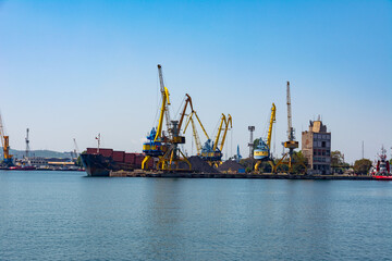 Photo of the pier and port cranes on a summer day