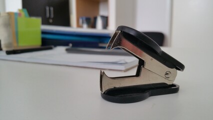black staple remover on the office desk