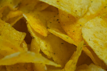 Spiced potato chips, a close-up shot. Fried potatoes.