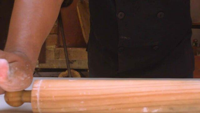 Wood-fired pizza. Pizza preparation in restaurant. Ketchup. kneading pizza. kiln. placing ingredients, tomato, cheese, mushroom, black olive, pepperoni, ham and peppers.
