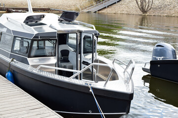 boat on the water at the pier in spring on a clear day 