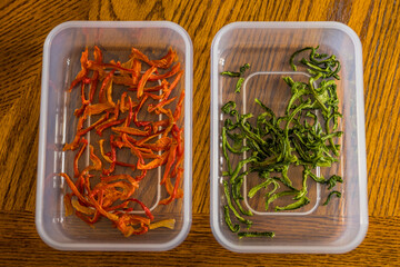 Prepared Dehydrated camp food ingredients, Red and Green bell peppers in a plastic container