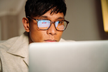 Asian male watching program online - Powered by Adobe