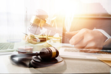 Justice and law concept.Male judge in a courtroom with the gavel, working with, computer and...