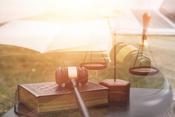 Justice and law concept.Male judge in a courtroom with the gavel, working with, computer and...