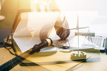 Justice and law concept.Male judge in a courtroom with the gavel, working with, computer and...