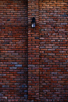Street lamp on red, old brick wall. © freeman83