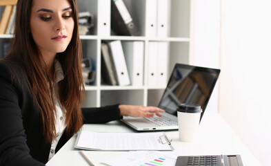 Obraz na płótnie Canvas Woman secretary on workplace, busy with planning, laptop device on desk