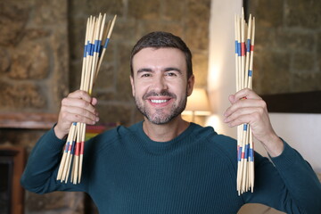 Man holding some mikado sticks