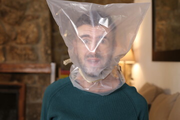 Man with head wrapped in plastic suffering from lack of air