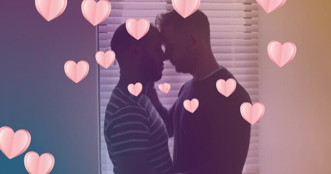 Animation of heart icons over diverse gay couple embracing