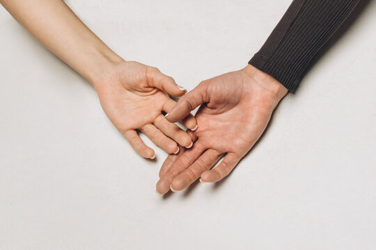 Two hands close-up on a white background, friendship and love, mutual assistance and nobility