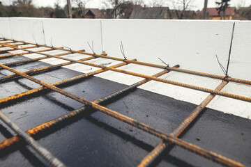 Reinforcement rods at construction site. Steel rebar mesh close up. Rusty steel reinforcement bars...