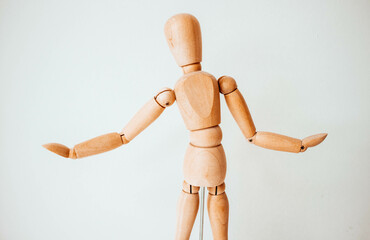 Wooden man on a white background. Copy space. Clean background