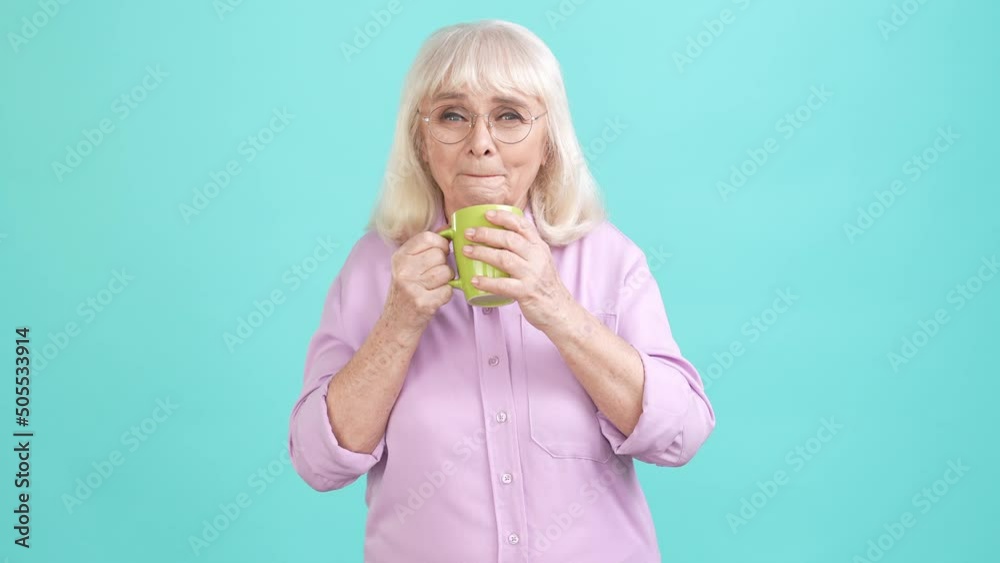 Poster aged lady drink hot latte enjoy coziness isolated cyan color background