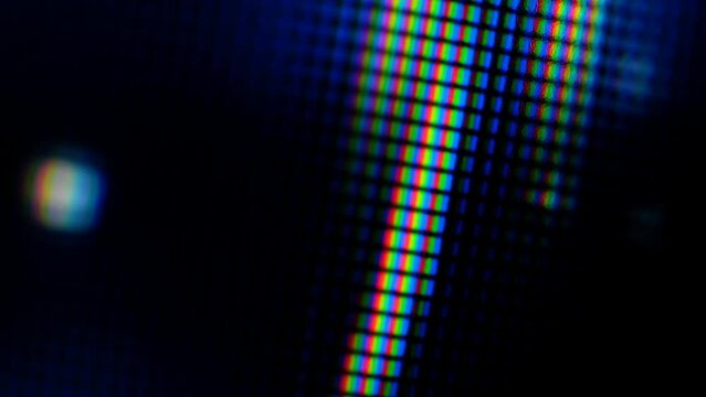Movement of abstract light spots from pixels on the device screen close-up, macro soft focus