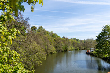 River Avon on a spring day, with blue skies and a boat on the river