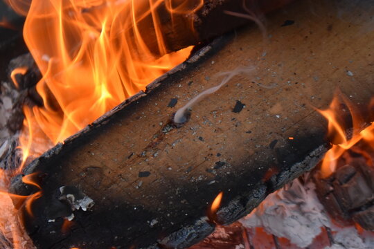 fire in a fireplace with smoke