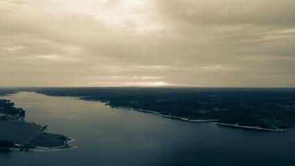 Aerial view of a huge sunrise over dam in Montargil in black and white environment