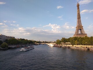 a view of the canal along with the Eiffel tower in the background 