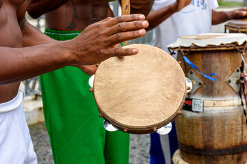 Fototapeta na wymiar Group of musicians playing tambourine and atabaque in the famous streets of Pelourinho in Salvador, Bahia