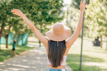 girl with hat on her back in summer outdoors