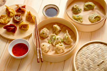 Traditional chinese dumplings served in the wooden bamboo steamer