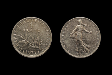 Closeup shot of a couple of 1 French Franc isolated on a dark background