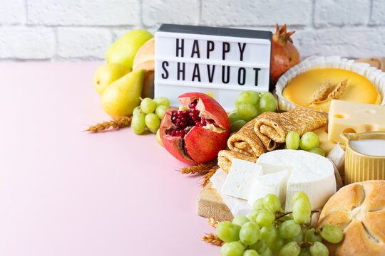 Jewish religious holiday Shavuot with dairy products, cheesecake, pancakes, fruits