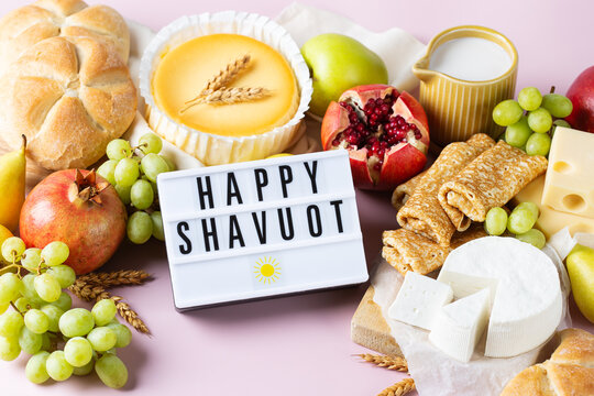 Jewish religious holiday Shavuot with dairy products, cheesecake, pancakes, fruits