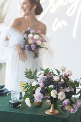 Beautiful attractive caucasian young woman in a white wedding dress with a bridal flower bouquet. Smiling