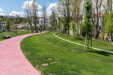 Beautiful shot of people walking on a pathway in Almonda park in the city center of Torres Novas