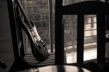 Electric guitar leaning on a wooden chair
