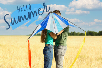 Happy young couple with kite in field. Hello, summer