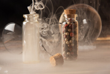 Small glasses with cork stopper with spices and empty, smoke, and more accessories, black...