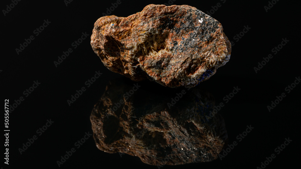 Sticker Aged mineral stone with iron ore on a black background