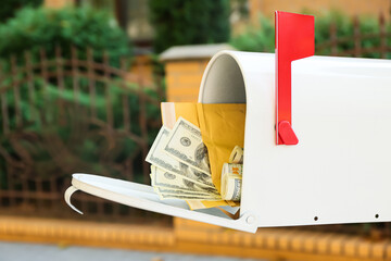 Vintage mailbox with money outdoors