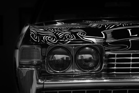 Grayscale closeup shot of painted lines on a Lowrider car