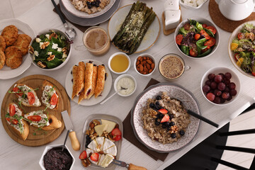 Many different dishes served on buffet table for brunch, flat lay