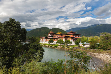 Fototapeta na wymiar Bhutan - October 24, 2021: The Punakha Dzong between the Pho Chhu and Mo Chhu river in Bhutan. Punakha Dzong Monastery, one of the largest monasteries in Asia, Until 1955 seat of the Bhutan government